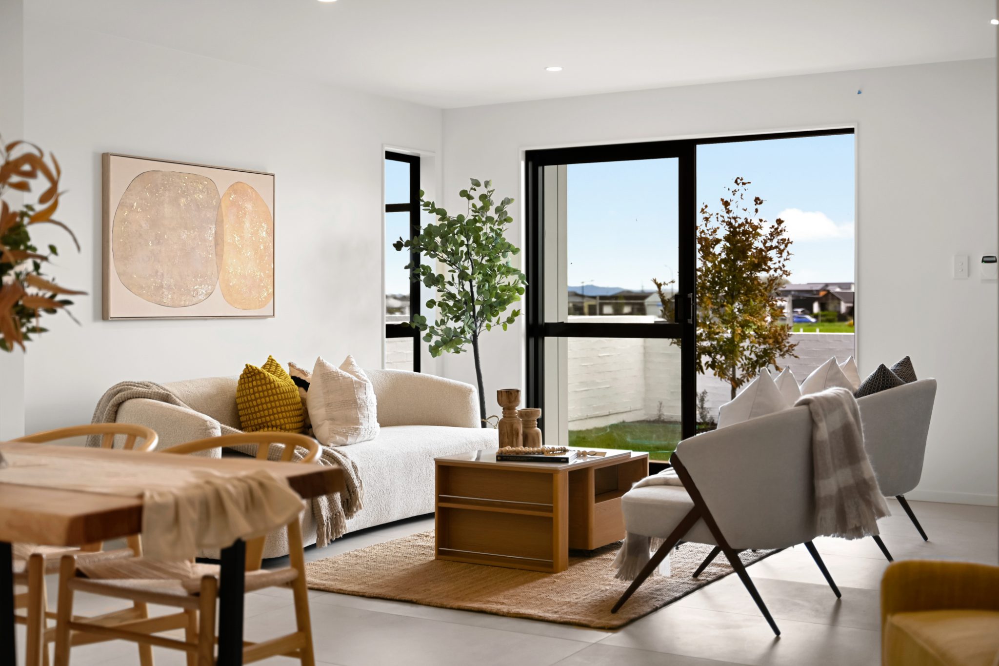 Living and dining room with large windows overlooking the garden