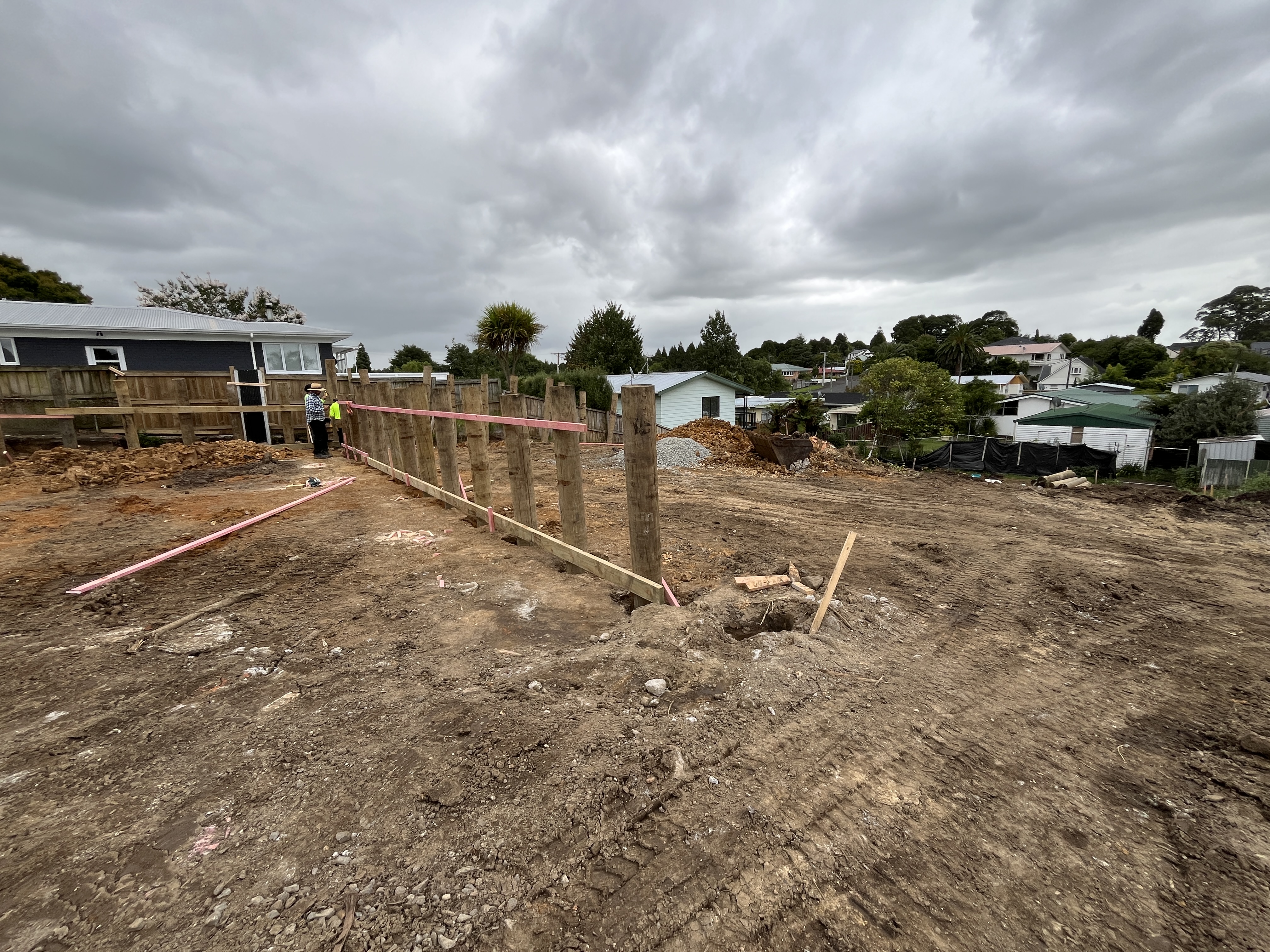 Site preparation and retaining wall posts at Storey Ave